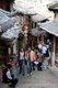 China: Tourists discovering the Old Town's back streets, Lijiang Old Town, Yunnan Province